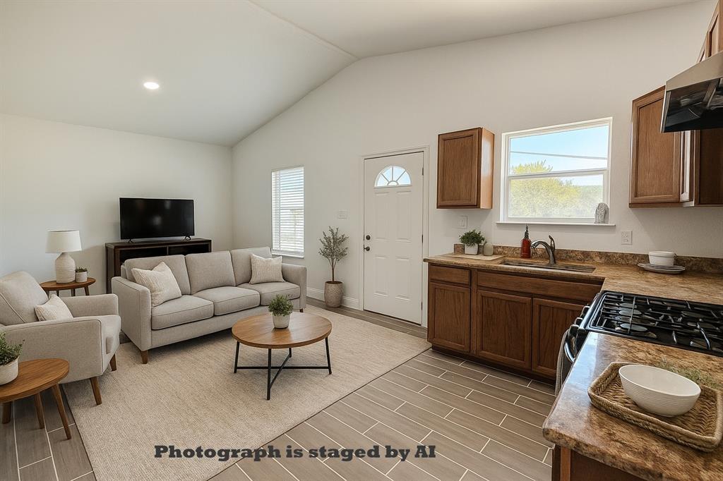 160 Summit Drive Springtown, TX 76082 - Photo 3 of 14 a living room with furniture a rug a window and a fireplace