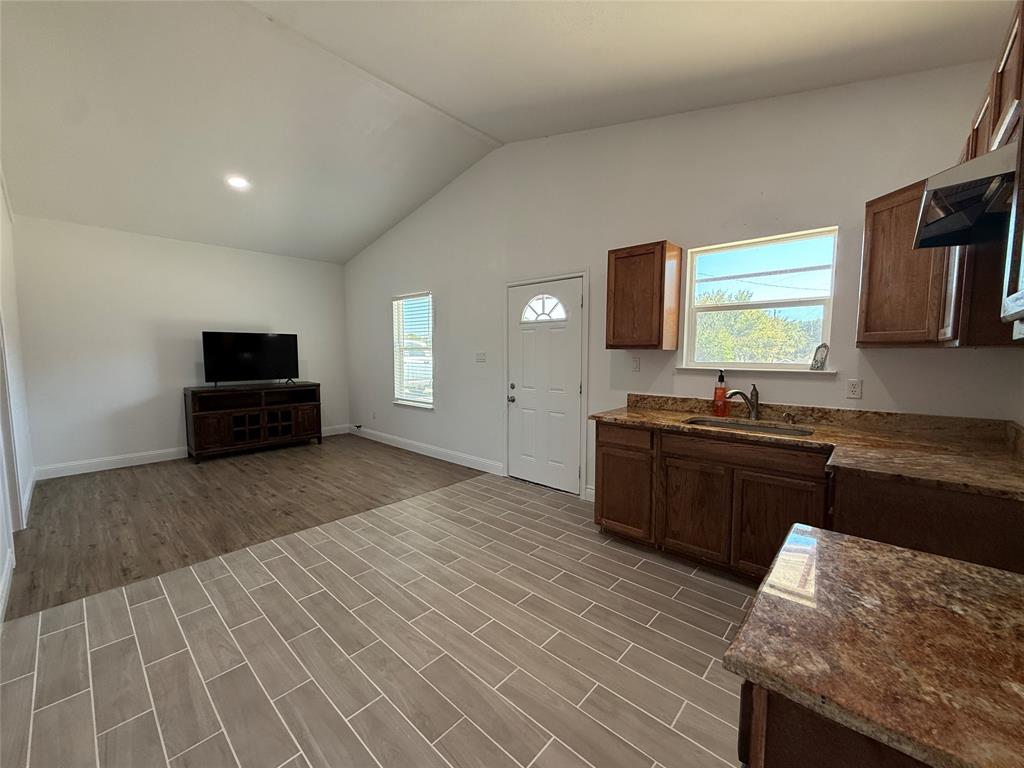 160 Summit Drive Springtown, TX 76082 - Photo 4 of 14 a kitchen with granite countertop a sink and a stove top oven