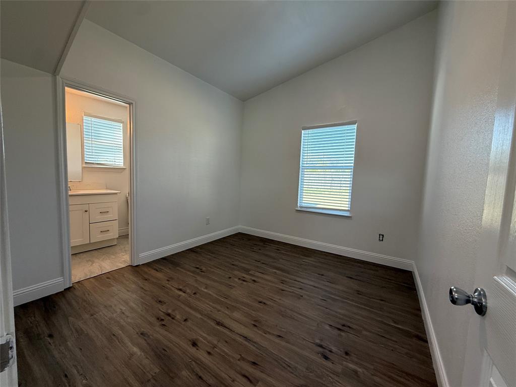 160 Summit Drive Springtown, TX 76082 - Photo 7 of 14 an empty room with wooden floor and windows