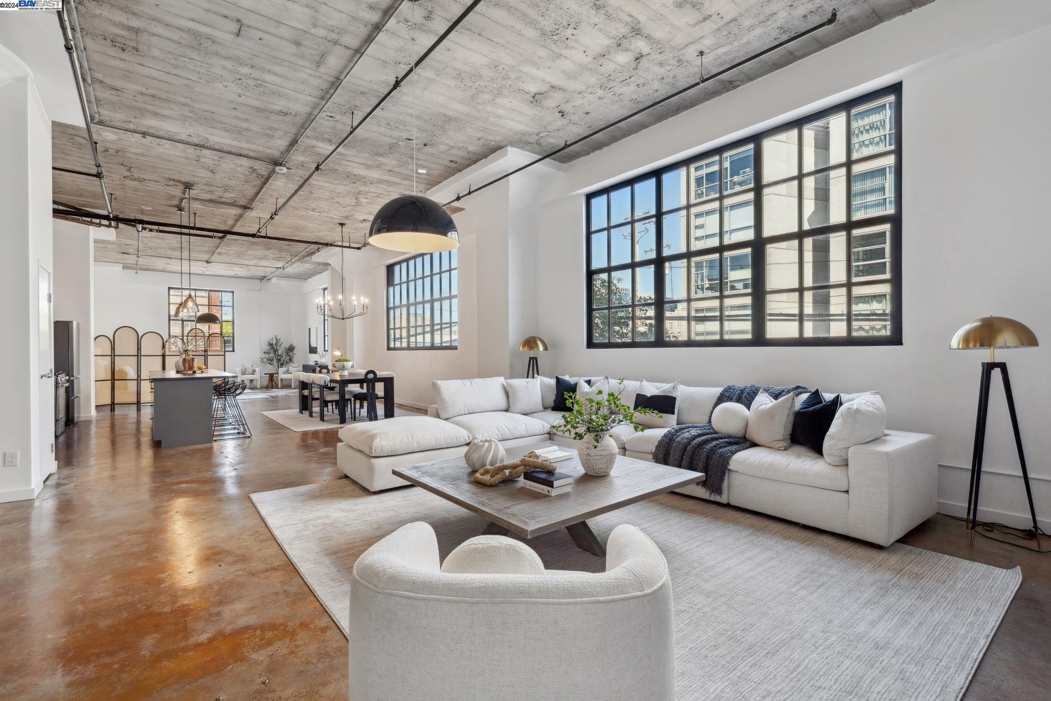 247 4th Street, Unit 202 Oakland, CA 94607 - Photo 1 of 1 a living room with furniture and a large window