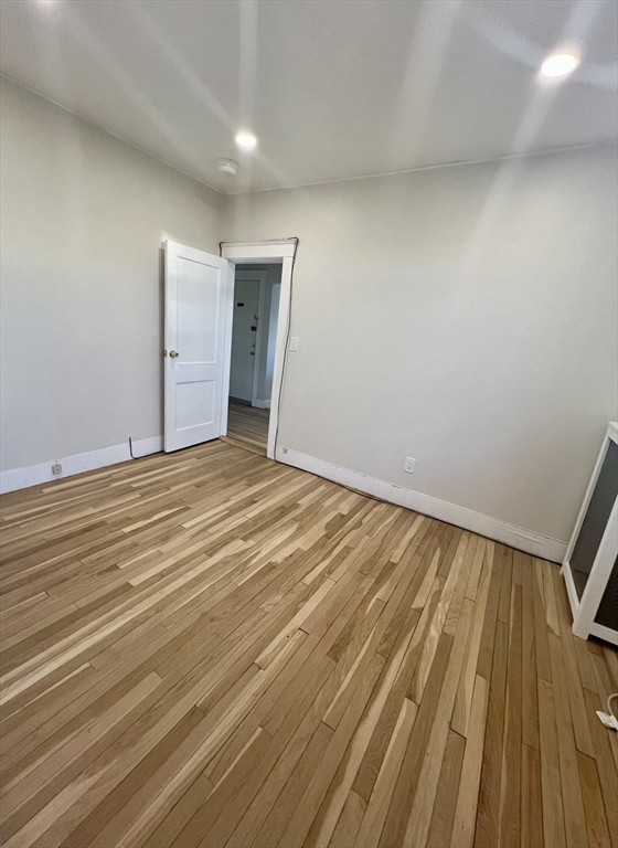 26 Chiswick Road, Unit 13 Boston, MA 02135 - Photo 13 of 19 a view of an empty room with wooden floor