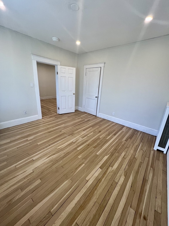 26 Chiswick Road, Unit 13 Boston, MA 02135 - Photo 17 of 19 a view of an empty room with wooden floor and a window