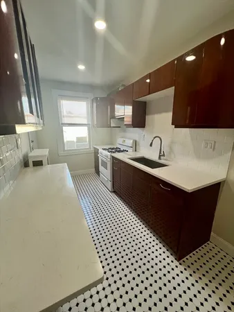 a kitchen with a sink and a stove top oven