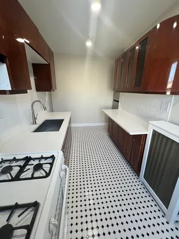 a kitchen with stainless steel appliances a refrigerator and a stove