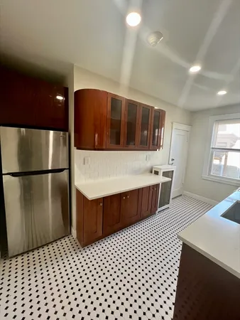 a bathroom with a sink a toilet a mirror and shower