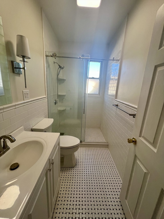 26 Chiswick Road, Unit 13 Boston, MA 02135 - Photo 9 of 19 a bathroom with a sink a toilet a mirror and shower