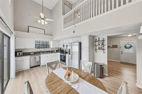 a kitchen with white cabinets and stainless steel appliances
