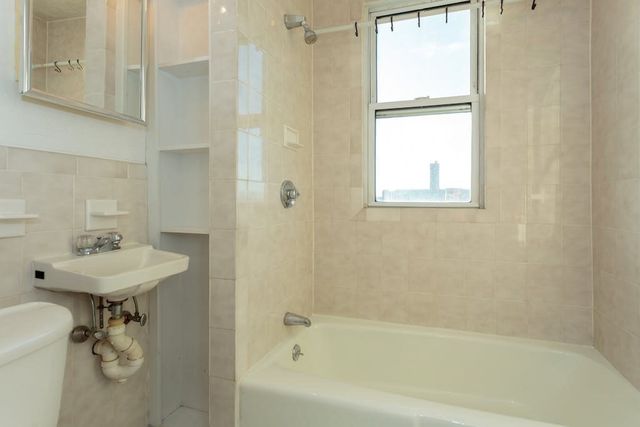 a bath room with a sink toilet and shower