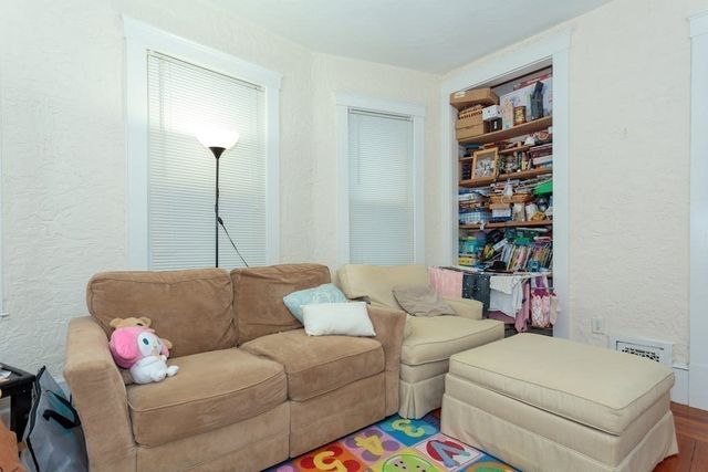 a living room with a couch and a bookshelf