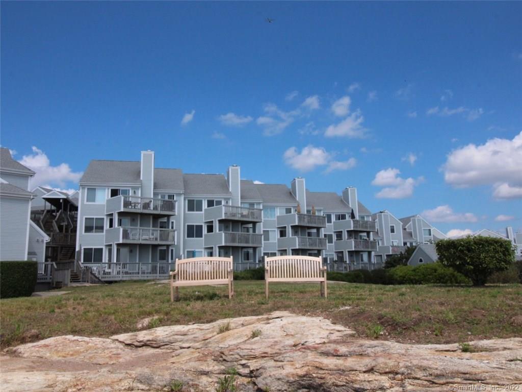 a view of a house with a yard and sitting area
