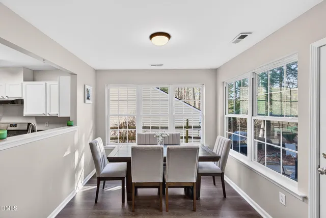 a dining room with furniture and wooden floor