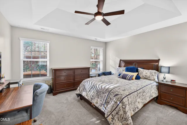 a bedroom with a bed a dresser and a couch