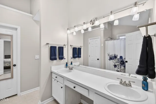 a bathroom with a sink vanity and a mirror