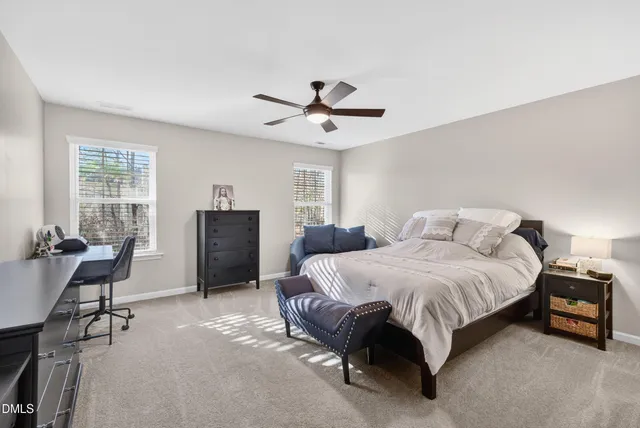a spacious bedroom with a bed and a chandelier