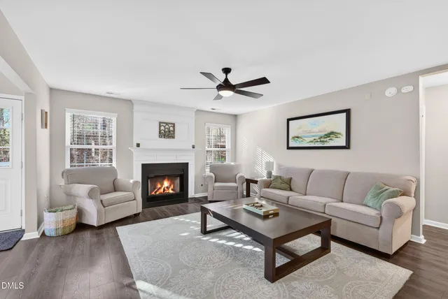 a living room with furniture a rug and a fireplace