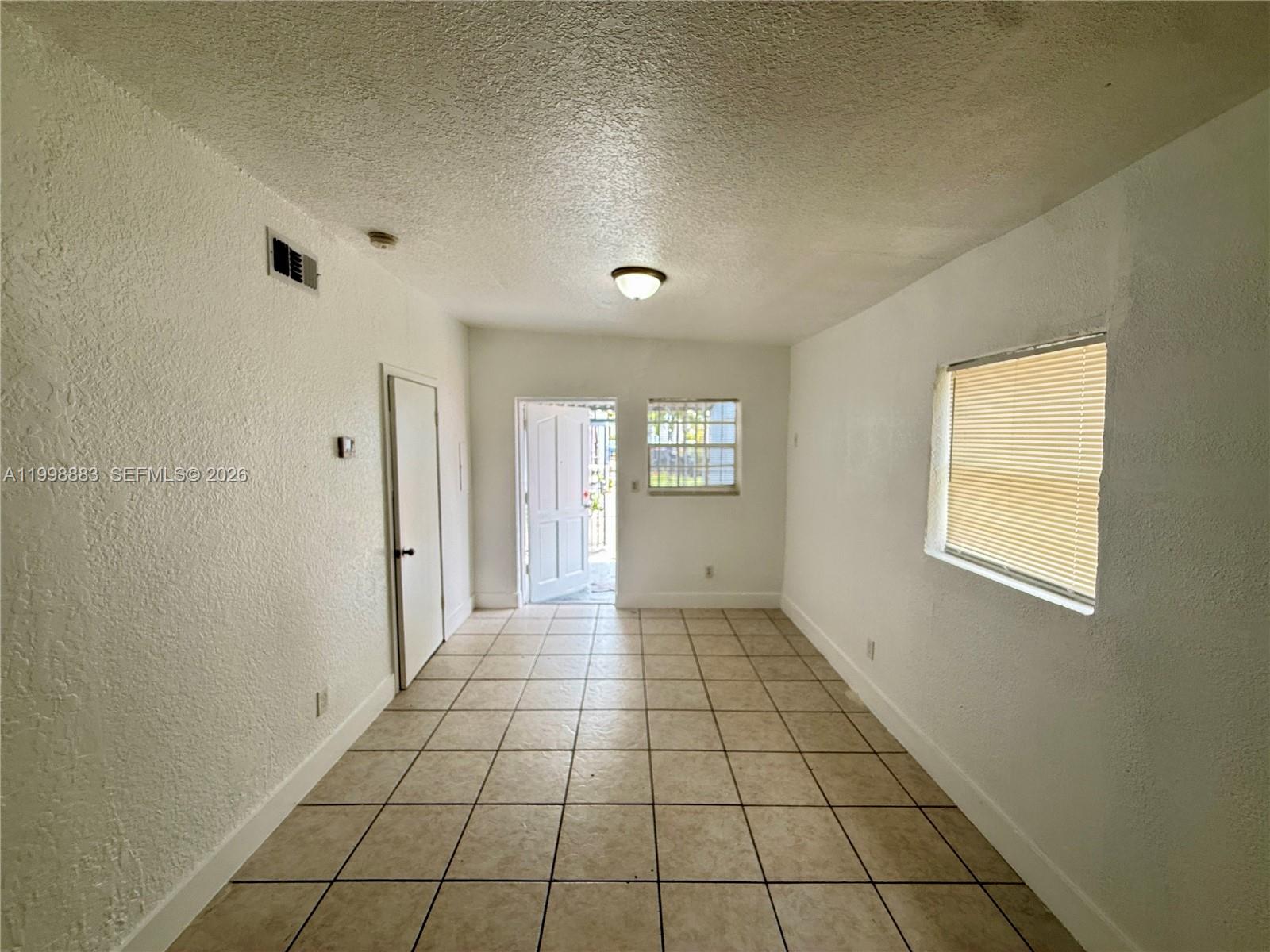 1345 Northwest 55th Street, Unit 2 Miami, FL 33142 - Photo 4 of 9 a view of an empty room and window