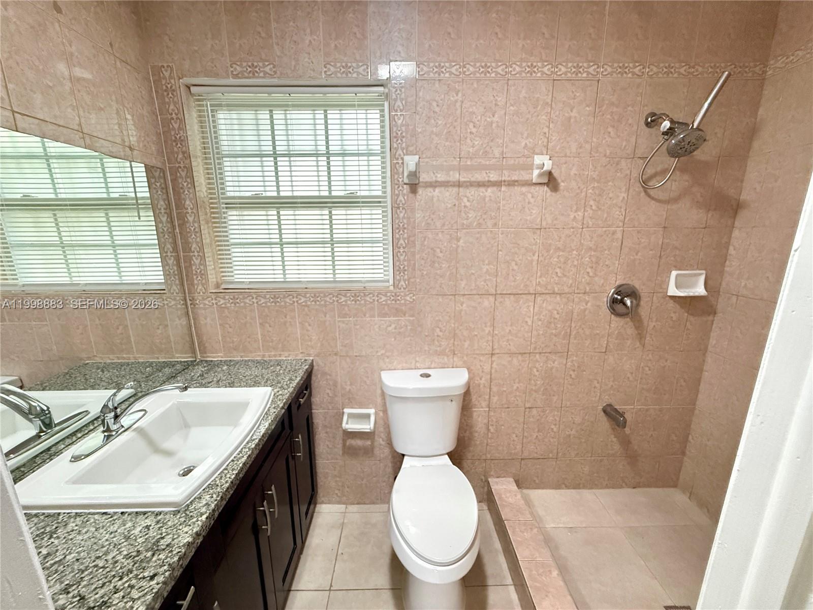 1345 Northwest 55th Street, Unit 2 Miami, FL 33142 - Photo 6 of 9 a bathroom with a sink toilet and shower