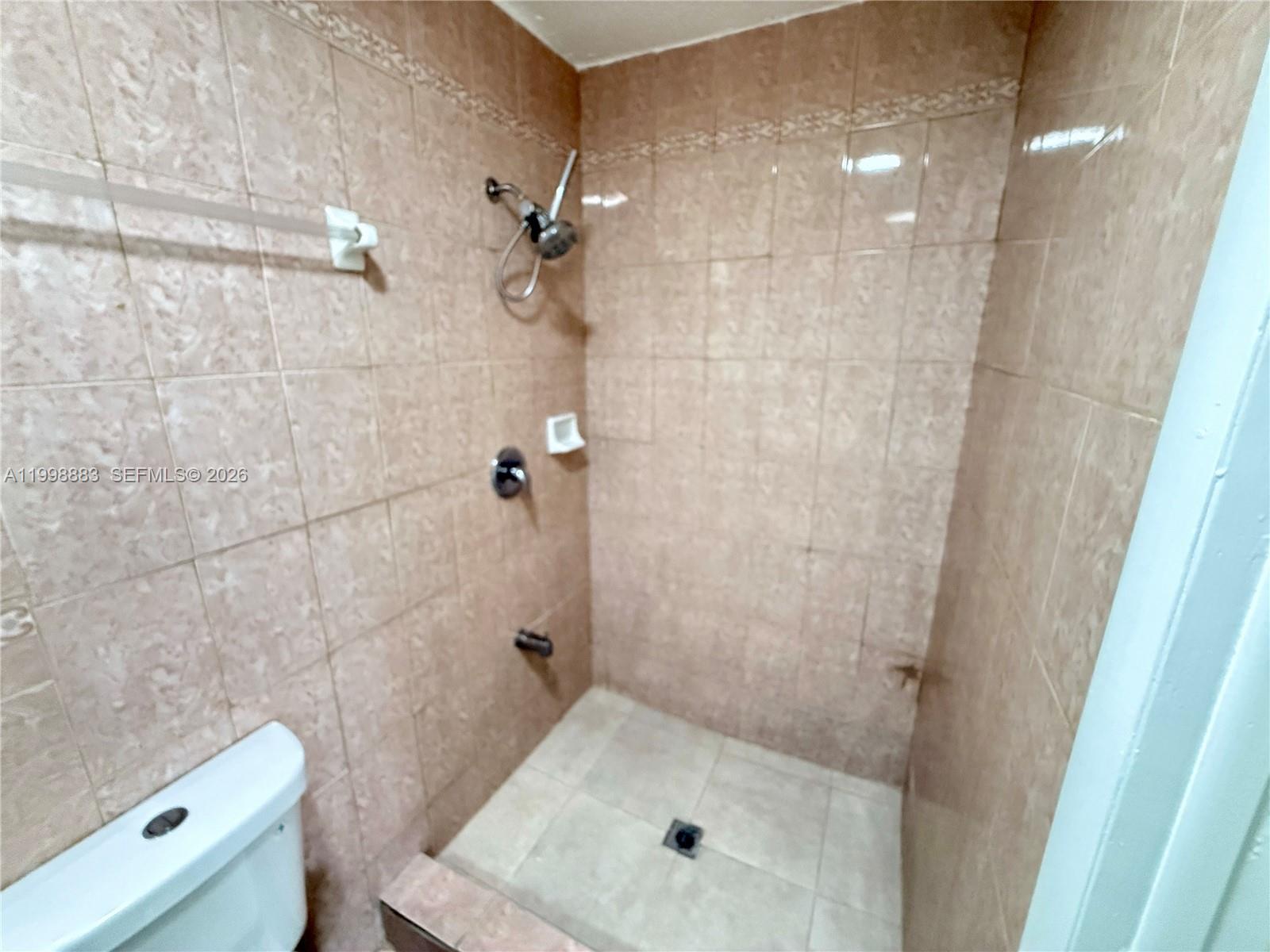 1345 Northwest 55th Street, Unit 2 Miami, FL 33142 - Photo 7 of 9 a bathroom with a shower and a toilet