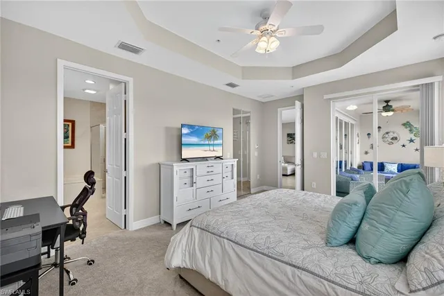 a bedroom with a bed and ceiling fan