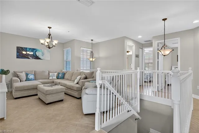 a living room with furniture a chandelier and a chandelier