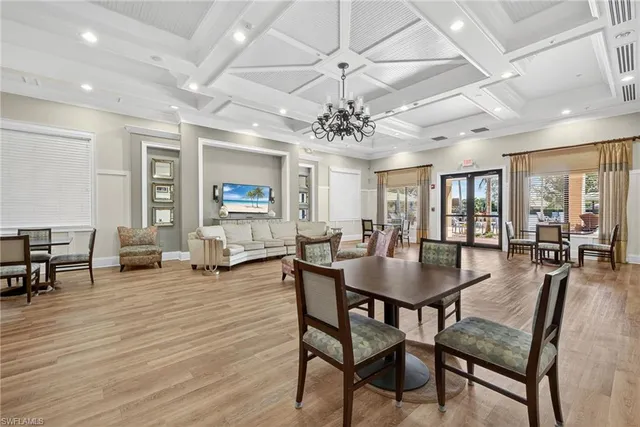 an aerial view of a house with a swimming pool and outdoor seating