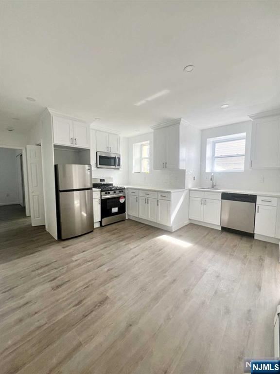 280 MacArthur Avenue, Unit 3 Garfield, NJ 07026 - Photo 1 of 15 a large kitchen with a refrigerator and a stove top oven