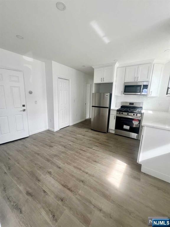 280 MacArthur Avenue, Unit 3 Garfield, NJ 07026 - Photo 2 of 15 a kitchen with a refrigerator a stove top oven a sink and dishwasher