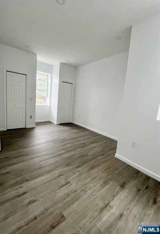 280 MacArthur Avenue, Unit 3 Garfield, NJ 07026 - Photo 7 of 15 a view of an empty room with wooden floor and a window