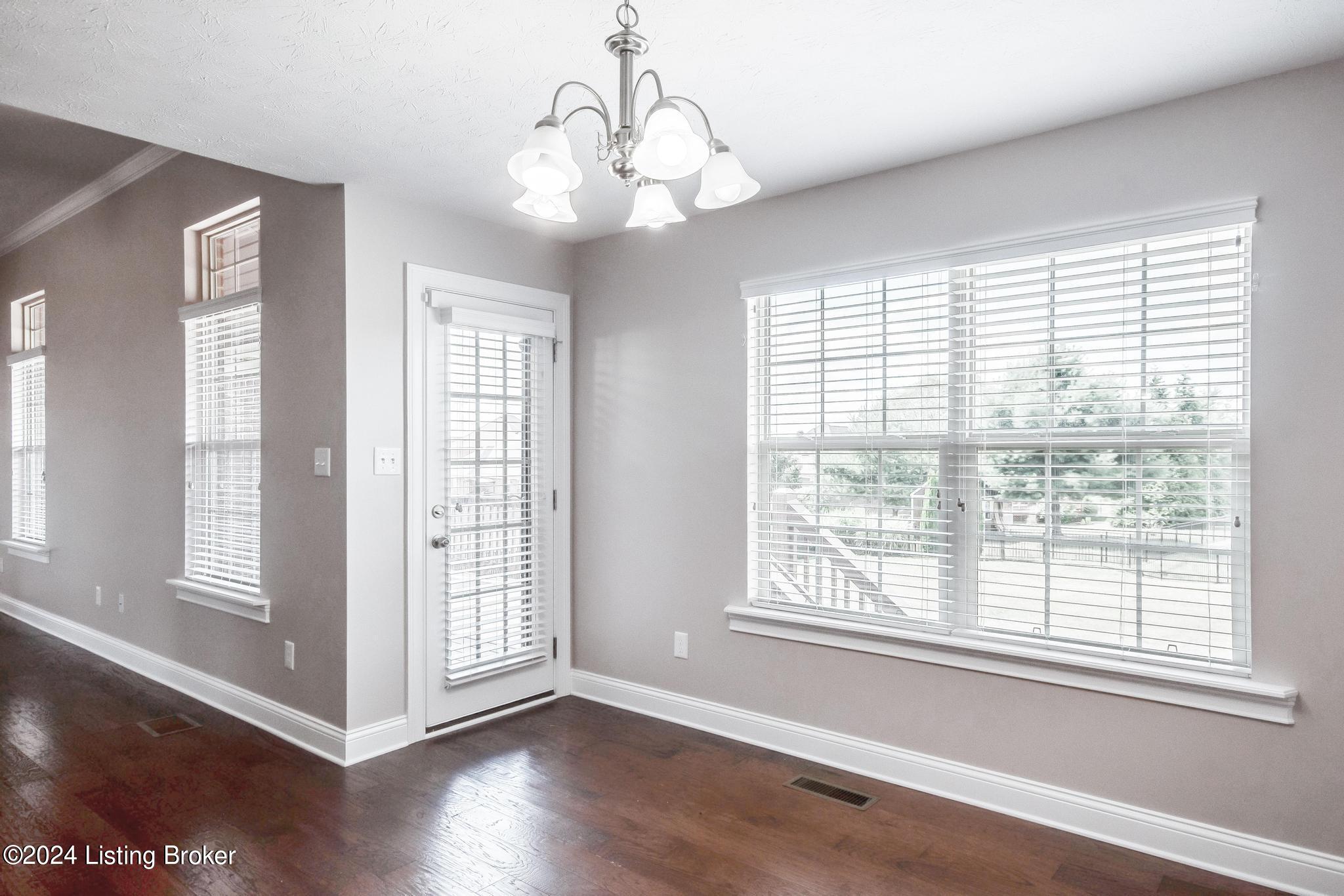 283 Autumn Ridge Drive Mount Washington, KY 40047 - Photo 11 of 41 Dining Area with chandelier, 2 windows and door to covered deck allowing lots of lighting, fresh coat of paint, gleaming wood flooring and wide open to the Eat-In Kitchen and the Great Room.