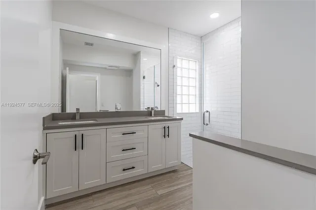 a bathroom with a granite countertop sink mirror and