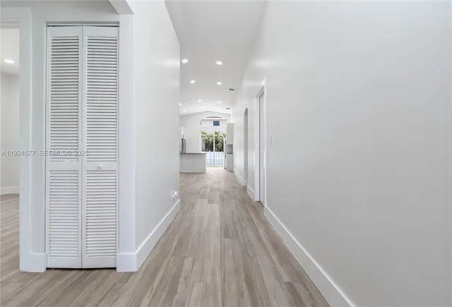 a view of hallway with wooden floor