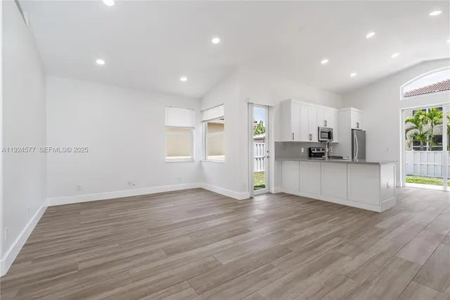 a view of kitchen with cabinets and wooden floor