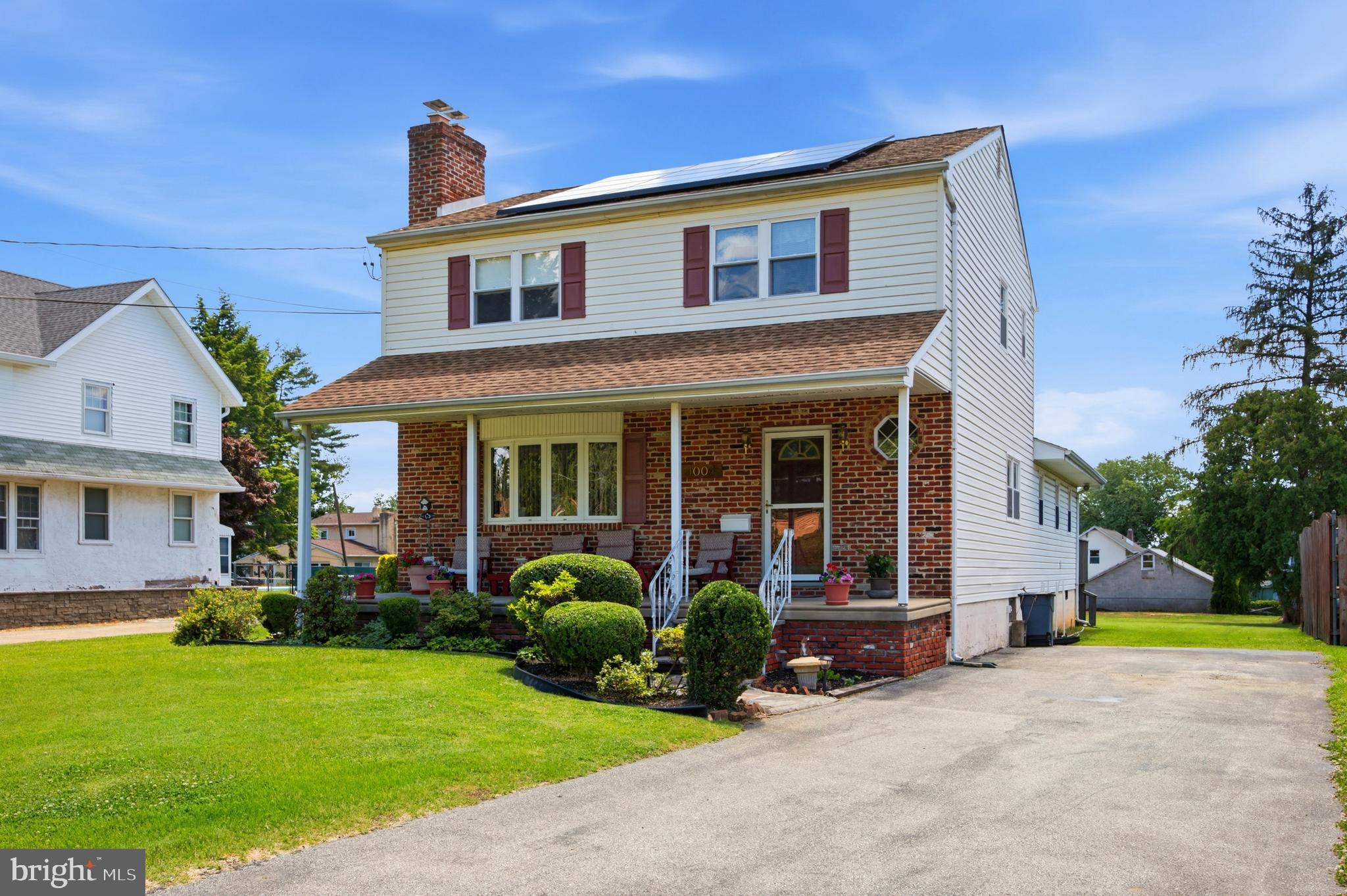 a front view of a house with garden and porch