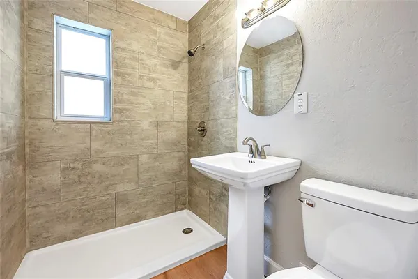 a bathroom with a sink toilet and shower