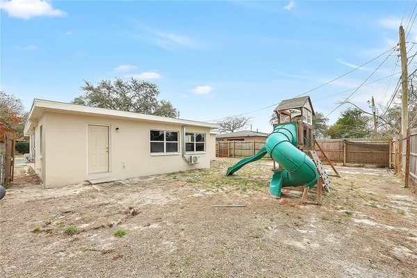 a view of a house with a backyard
