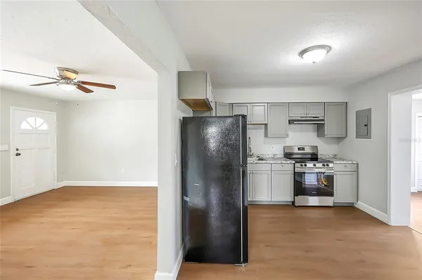 a kitchen with stainless steel appliances granite countertop a refrigerator and a stove