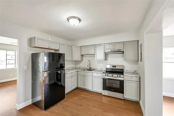 a kitchen with stainless steel appliances a refrigerator stove and microwave