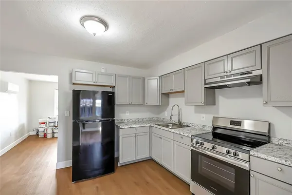 a kitchen with cabinets and steel stainless steel appliances
