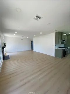 a view of kitchen and empty room