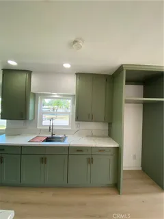 a kitchen with a sink and a mirror