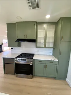 a kitchen with a stove and a cabinet