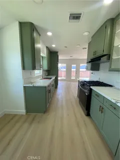 a large kitchen with stainless steel appliances granite countertop a large counter top and a stove