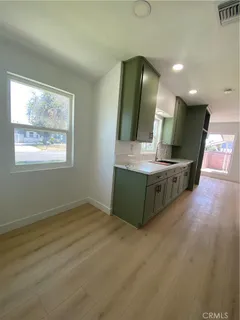 a spacious bathroom with a double vanity sink and a large mirror
