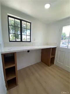 a room with wooden floor and window
