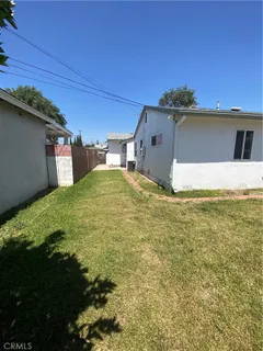 a view of a big yard with an outdoor seating