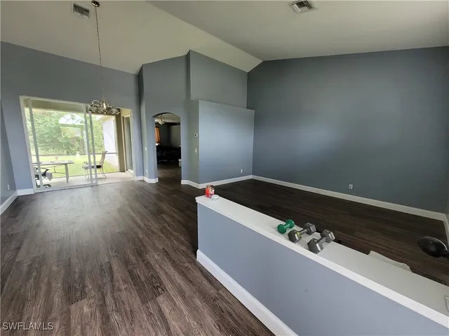 a room with wooden floor and window