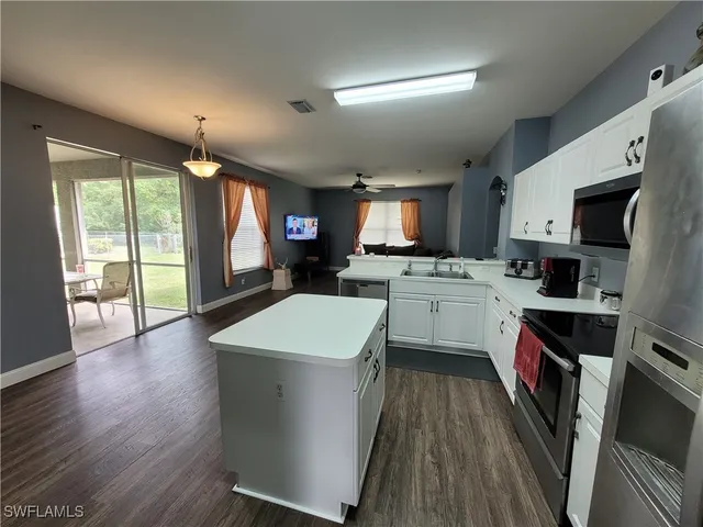 a kitchen with a sink stove and cabinets
