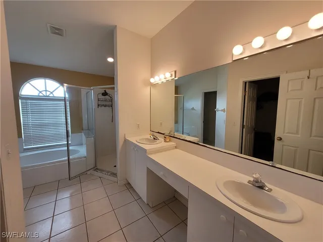 a bathroom with a double vanity sink mirror and double