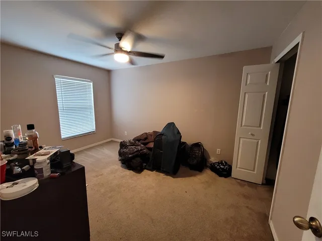 a bed room with a bed a couch and a dresser