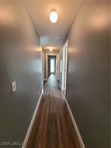 a view of hallway with wooden floor
